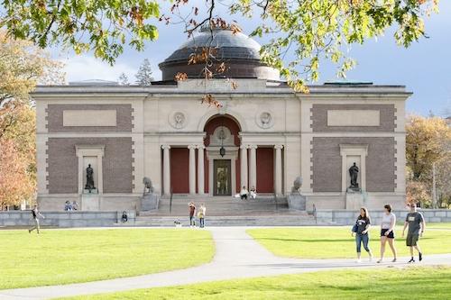 People walking in front of the Museum of Art